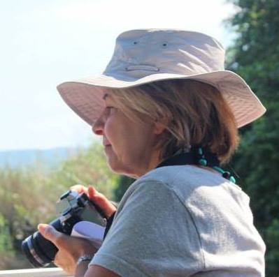 Frances Berger, a photographer based in Pinner, holding her camera